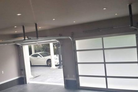 Newly installed double electric glass garage doors in Arlington modern home interior view
