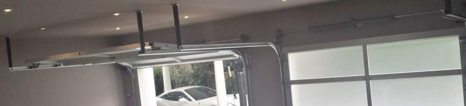 Newly installed double electric glass garage doors in Arlington modern home interior view