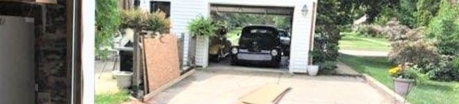 Partially installed new garage door with framing details visible – Cedar Hill home project