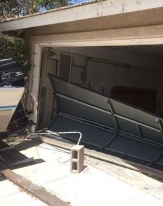 Collapsed overhead garage door at Cedar Hill home before emergency replacement